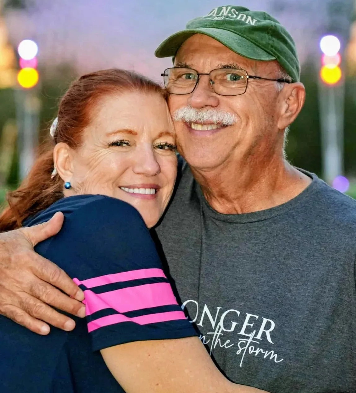 Paul and Loring Hammond, cheek to cheek, smiling at golden hour.